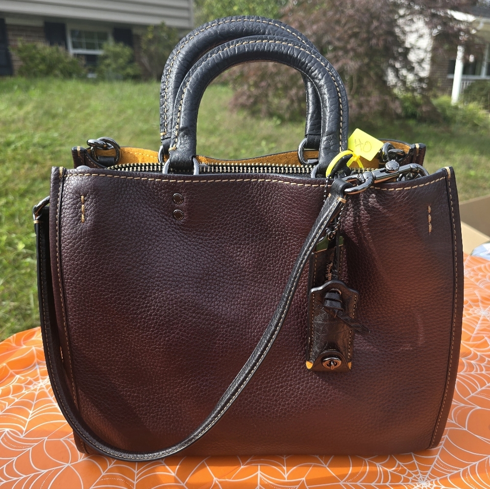 Coach Rogue 1941 bag in oxblood pebbled leather with whipstitch handles.